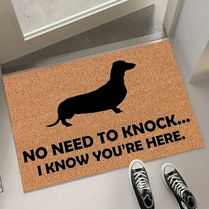 Un adorable tapis de bienvenue en forme de teckel brun ou noir
