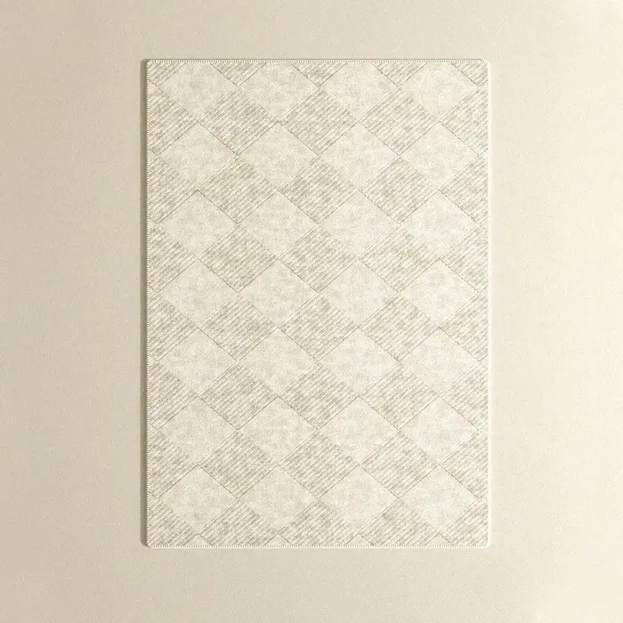 Tapis de grande surface beige à motif géométrique